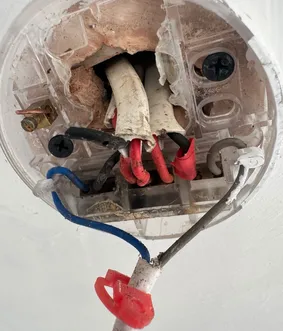 Light fixture wiring being checked before installation