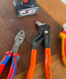 Pliers and adjustable wrenches used for plumbing repairs